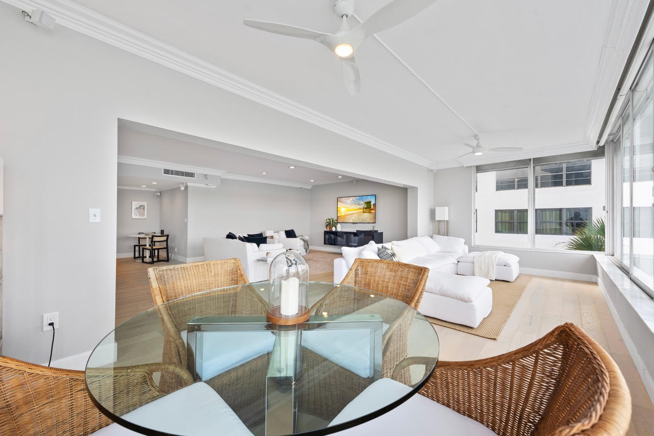 Single-story house with a two-car garage, neatly trimmed lawn, small palm trees, and a "For Rent" sign in the front yard beneath a clear blue sky—ideal for those seeking Homes for Rent in Naples.